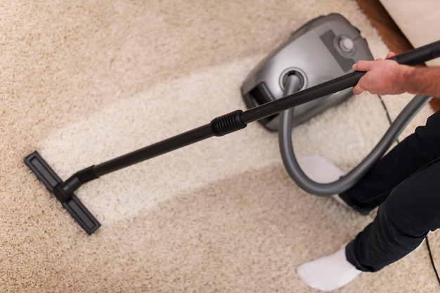 Free photo close up of vacuuming a carpet