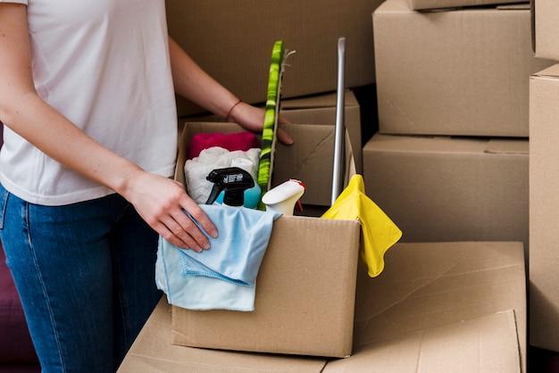 Free photo crop woman packing boxes