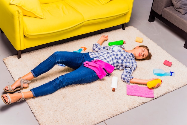 Free photo exhausted young woman after cleaning the house