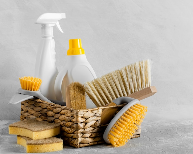 Free photo front view of eco-friendly cleaning brushes in basket with solution