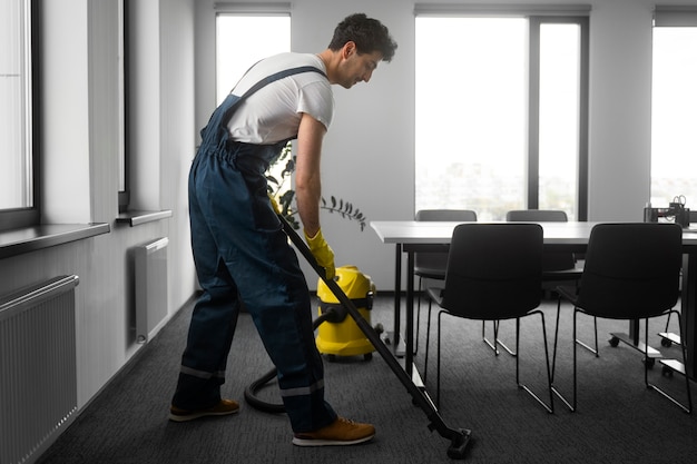 Free photo full shot man cleaning indoors