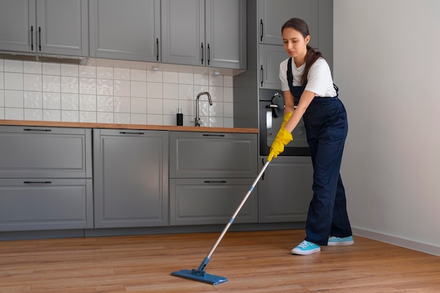 Free photo full shot woman cleaning home