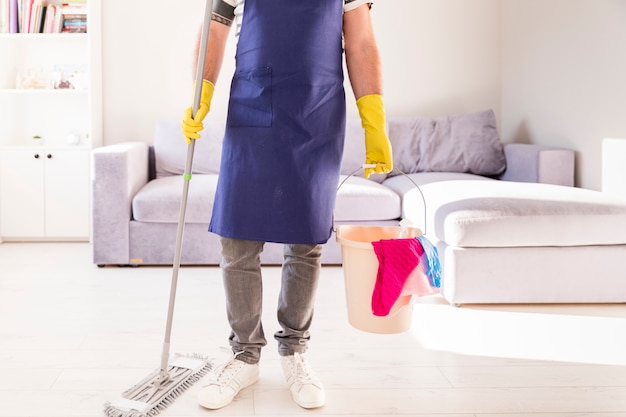 Free photo man cleaning his home