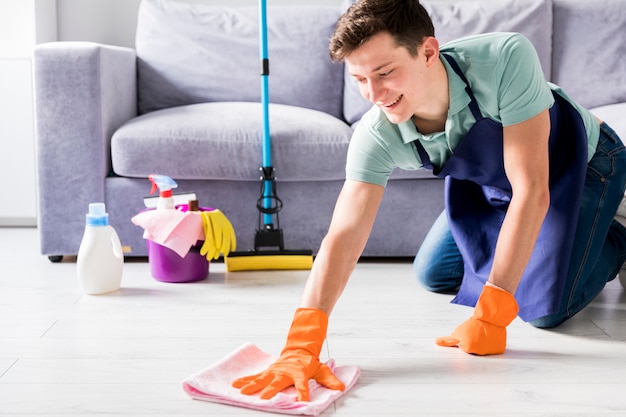 Free photo man cleaning his home