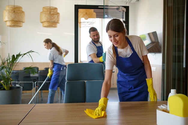 Free photo professional cleaning service people working together in an office
