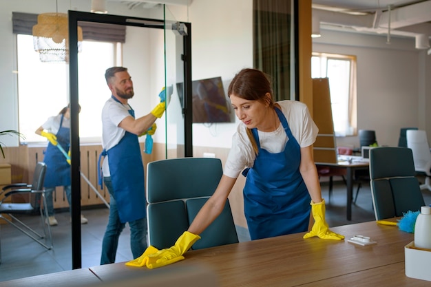Free photo professional cleaning service people working together in an office
