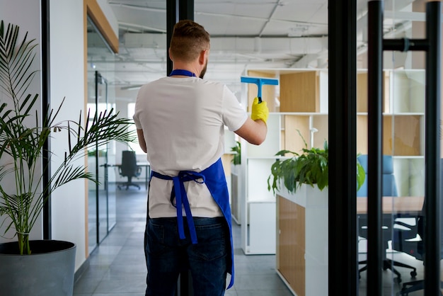 Free photo professional cleaning service person cleaning office window