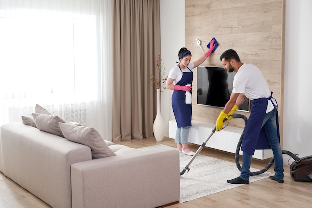 Photo professional cleaning service team cleans living room in modern apartment