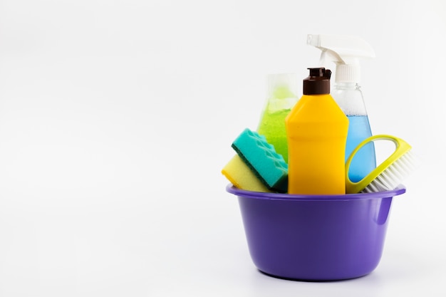 Free photo purple basin with different cleaning items