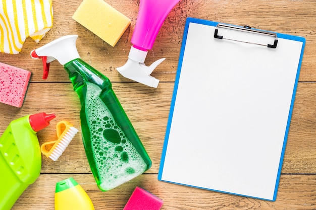 Free photo above view arrangement with cleaning products and clipboard