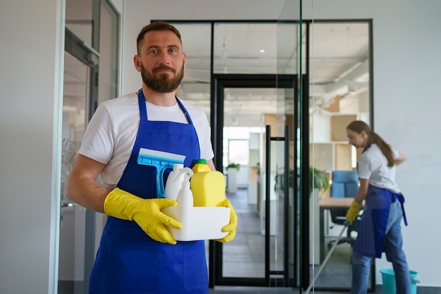 Free photo view of professional cleaning service person holding supplies