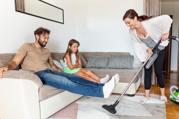 Free photo woman vacuuming the carpet