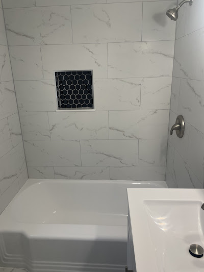 Pristine bathtub and tile work after post-renovation cleaning in Brookline