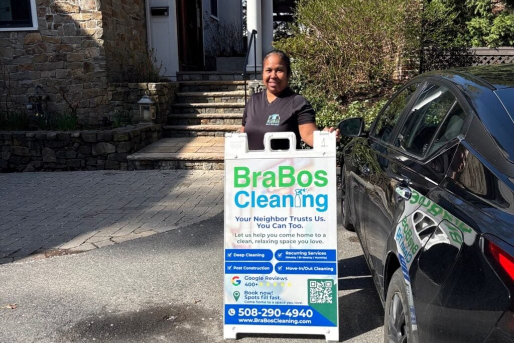 Brabos Cleaning member next to a Brabos sign in cambridge